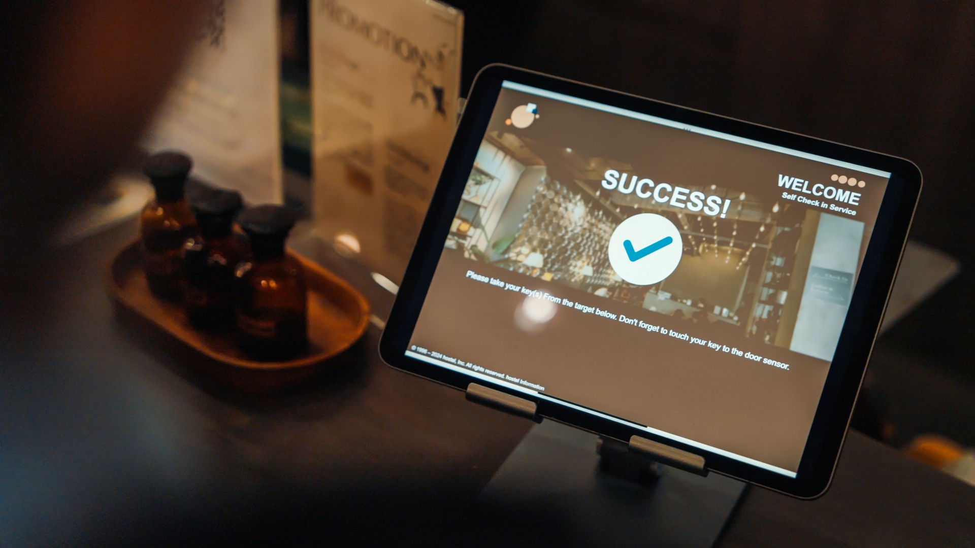 Over the shoulder Self Check-In Success on Tablet at Hostel